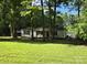 Charming single story home with a covered porch and large yard surrounded by mature trees at 850 Meadowbend Dr, York, SC 29745