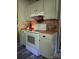 Rustic kitchen features white appliances, cabinetry, and a brick accent wall above the oven at 850 Meadowbend Dr, York, SC 29745