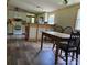 Bright kitchen and dining area with white cabinetry, butcher block counters, and wood-style flooring at 850 Meadowbend Dr, York, SC 29745