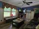 Cozy living room with dark blue walls, wood trim, comfortable seating, and natural light at 850 Meadowbend Dr, York, SC 29745