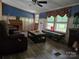 Bright living room with wood-look flooring, large windows, and comfortable seating arrangement at 850 Meadowbend Dr, York, SC 29745