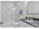 Bathroom with marble shower, glass enclosure, and a vanity with a dark countertop and modern fixtures at 9750 Briarwick Ln, Charlotte, NC 28277