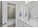 Well-lit bathroom showcasing a tiled shower, tub, and vanity with great countertop space at 9750 Briarwick Ln, Charlotte, NC 28277
