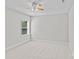 Bright bedroom featuring neutral walls, plush carpet, and a ceiling fan for added comfort at 9750 Briarwick Ln, Charlotte, NC 28277