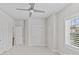 Bright bedroom featuring neutral walls, plush carpet, and natural light from the window at 9750 Briarwick Ln, Charlotte, NC 28277