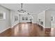 Bonus room featuring hardwood floors, a ceiling fan, and a treadmill, creating a versatile space at 9750 Briarwick Ln, Charlotte, NC 28277