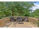 Outdoor deck featuring stylish wicker furniture, ideal for relaxation, surrounded by lush greenery at 9750 Briarwick Ln, Charlotte, NC 28277