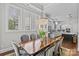 Elegant dining area with a crystal chandelier, lots of windows and views, and hardwood floors at 9750 Briarwick Ln, Charlotte, NC 28277