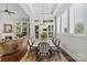 Elegant dining room with coffered ceilings, lots of windows with views, and an elaborate chandelier at 9750 Briarwick Ln, Charlotte, NC 28277