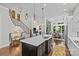 Spacious kitchen featuring a large island, staircase, and dining area at 9750 Briarwick Ln, Charlotte, NC 28277