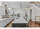 Modern kitchen with gray cabinets, stainless steel appliances, and large island with seating at 9750 Briarwick Ln, Charlotte, NC 28277