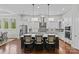 Modern kitchen with gray cabinets, stainless steel appliances, and large island with seating at 9750 Briarwick Ln, Charlotte, NC 28277