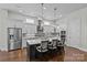 Modern kitchen with gray cabinets, stainless steel appliances, and large island with seating at 9750 Briarwick Ln, Charlotte, NC 28277