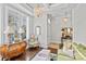 Elegant living room with hardwood floors, coffered ceiling, and sophisticated decor at 9750 Briarwick Ln, Charlotte, NC 28277
