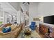 Open-concept living room boasts high ceilings, hardwood floors, and a staircase with wood banister at 9750 Briarwick Ln, Charlotte, NC 28277