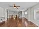 Bright living room with hardwood floors, staircase, stylish lighting, and large windows providing ample natural light at 9750 Briarwick Ln, Charlotte, NC 28277