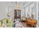 Elegant living room with hardwood floors, coffered ceiling, and sophisticated decor at 9750 Briarwick Ln, Charlotte, NC 28277