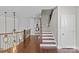 Hallway staircase featuring wood and white accents, elegant lighting, and an open design at 9750 Briarwick Ln, Charlotte, NC 28277
