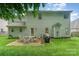 Large backyard featuring a patio with seating, a grill, and well-maintained lawn at 10322 Stoneykirk Ln, Charlotte, NC 28269