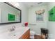 Bathroom with decorative window shade and vanity with solid surface countertop at 10322 Stoneykirk Ln, Charlotte, NC 28269