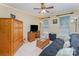 Comfortable bedroom with ceiling fan, TV, and window providing natural light at 10322 Stoneykirk Ln, Charlotte, NC 28269