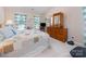 Bedroom featuring bright windows with a ceiling fan and a dresser with mirror at 10322 Stoneykirk Ln, Charlotte, NC 28269