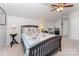 Bedroom with a ceiling fan, a bed with patchwork quilt, and a side table with lamp at 10322 Stoneykirk Ln, Charlotte, NC 28269