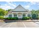 Charming community clubhouse with white siding, green shutters, and a welcoming front porch at 10322 Stoneykirk Ln, Charlotte, NC 28269