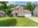 Charming two-story home featuring brick accents, red shutters, and a well-manicured lawn at 10322 Stoneykirk Ln, Charlotte, NC 28269