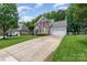 Beautiful brick front home with a two-car garage, long driveway, and manicured lawn at 10322 Stoneykirk Ln, Charlotte, NC 28269