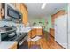 Well-lit kitchen featuring stainless appliances, wood cabinets, and a breakfast bar at 10322 Stoneykirk Ln, Charlotte, NC 28269