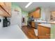Functional kitchen features stainless appliances, wood cabinets, and a view of the dining area at 10322 Stoneykirk Ln, Charlotte, NC 28269