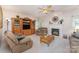 Cozy living room with fireplace, ceiling fan, and comfortable seating at 10322 Stoneykirk Ln, Charlotte, NC 28269