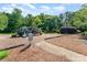 Community playground with slides and climbing structures on a mulched surface with surrounding trees at 10322 Stoneykirk Ln, Charlotte, NC 28269