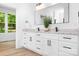 Bright bathroom featuring a double vanity with granite countertop, modern fixtures, and natural light at 104 Arbor Dr, Waxhaw, NC 28173