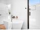 Modern bathroom with soaking tub, stand alone shower, hardwood floors, and white walls at 104 Arbor Dr, Waxhaw, NC 28173