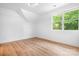 Bright bedroom with hardwood flooring, a large window, and neutral walls at 104 Arbor Dr, Waxhaw, NC 28173