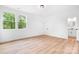 Bright bedroom featuring hardwood floors, white walls, and ample natural light through large windows at 104 Arbor Dr, Waxhaw, NC 28173