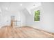 Bright bonus room with hardwood floors and a large window letting in natural light at 104 Arbor Dr, Waxhaw, NC 28173