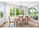 Bright dining room with a modern chandelier, large windows, and access to outdoor deck at 104 Arbor Dr, Waxhaw, NC 28173