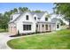 Beautiful two-story modern farmhouse with white siding, dark roof, and a welcoming front porch at 104 Arbor Dr, Waxhaw, NC 28173