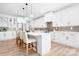 Modern kitchen featuring a large island with seating, stainless steel appliances, and white cabinetry at 104 Arbor Dr, Waxhaw, NC 28173