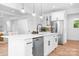 Modern kitchen with a large island, stainless steel appliances, and sleek white cabinetry at 104 Arbor Dr, Waxhaw, NC 28173