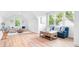 Bright living room featuring hardwood floors, white walls, and ample natural light through large windows at 104 Arbor Dr, Waxhaw, NC 28173