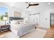 Bright main bedroom boasts a ceiling fan, hardwood floors, and access to an ensuite bathroom at 104 Arbor Dr, Waxhaw, NC 28173