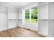Spacious walk-in closet with built-in shelving and hardwood floors at 104 Arbor Dr, Waxhaw, NC 28173