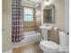 Bathroom features a tub with tile surround, a pedestal sink, and a toilet at 108 Greenwood Ave, Belmont, NC 28012