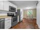 Modern kitchen with stainless steel appliances and ample cabinet space, seamlessly connecting to the dining area, perfect for entertaining at 108 Greenwood Ave, Belmont, NC 28012