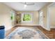 Bright living room with hardwood floors, large windows offering green views, and a charming decor, creating a cozy atmosphere at 108 Greenwood Ave, Belmont, NC 28012