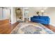Inviting living room with hardwood floors, a stylish blue sofa, and a beautiful patterned rug, perfect for relaxation and gatherings at 108 Greenwood Ave, Belmont, NC 28012